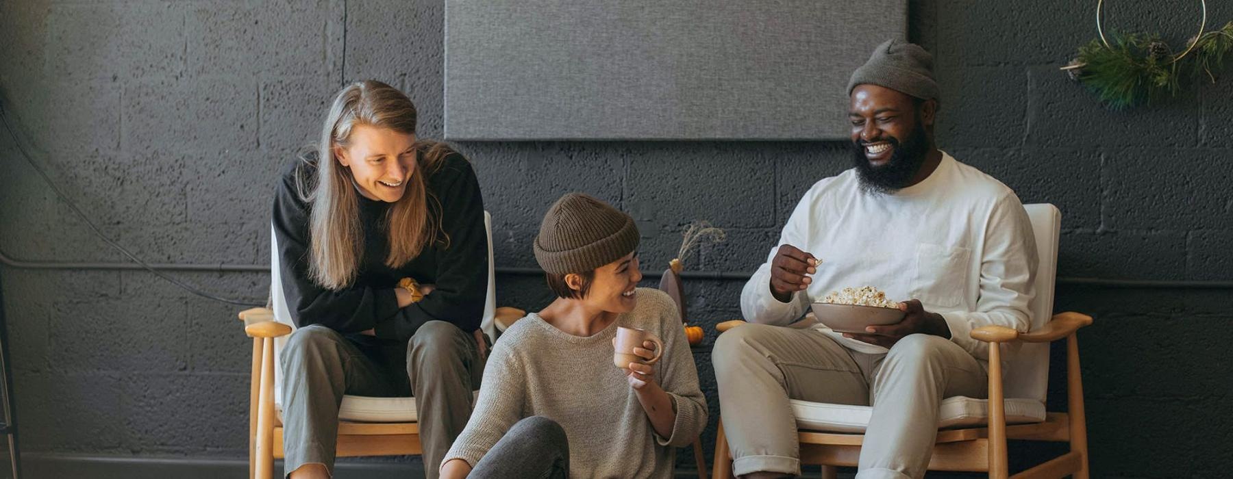 friends sit together around an open laptop